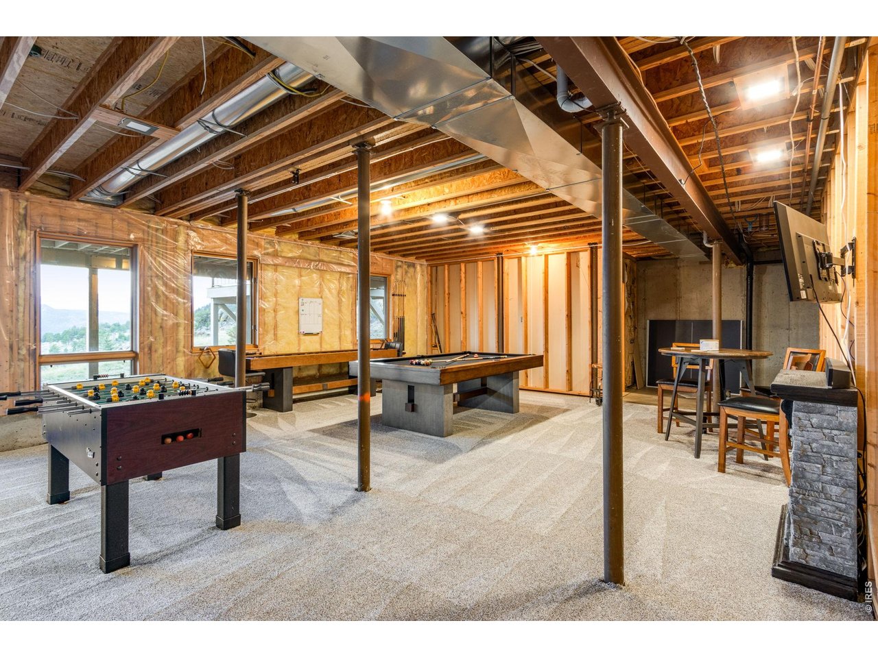 Property Photo 43 The walk-out basement is the perfect gathering spot for pool, foosball, and gaming. It also has plenty of additional storage space.