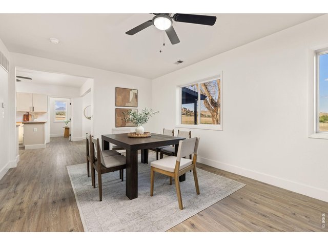 Property Photo 9 Dining area conveniently positioned between the living room and kitchen for an easy, open flow.