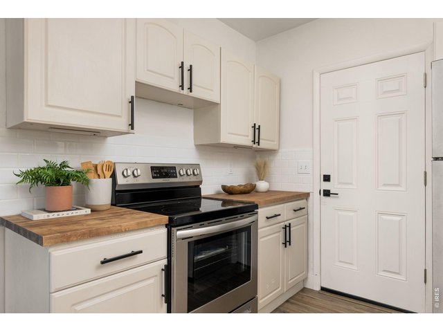 Property Photo 12 Updated kitchen combines clean finishes with practical workspace and storage.