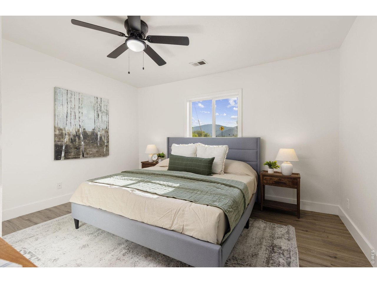 Property Photo 14 Comfortable main-level bedroom with updated flooring and finishes.