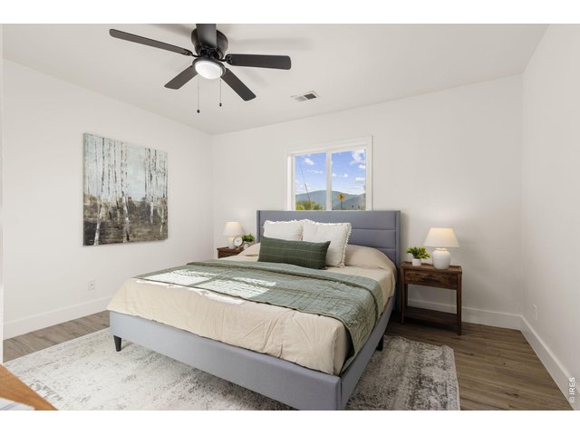 Property Photo 14 Comfortable main-level bedroom with updated flooring and finishes.