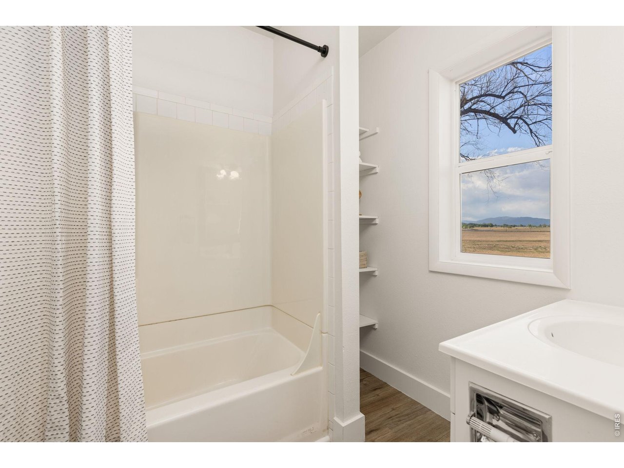 Property Photo 16 Updated main-level full bath with clean, simple finishes.