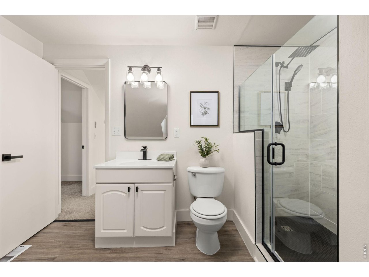 Property Photo 18 Second updated bath features a walk-in shower and clean, simple finishes.