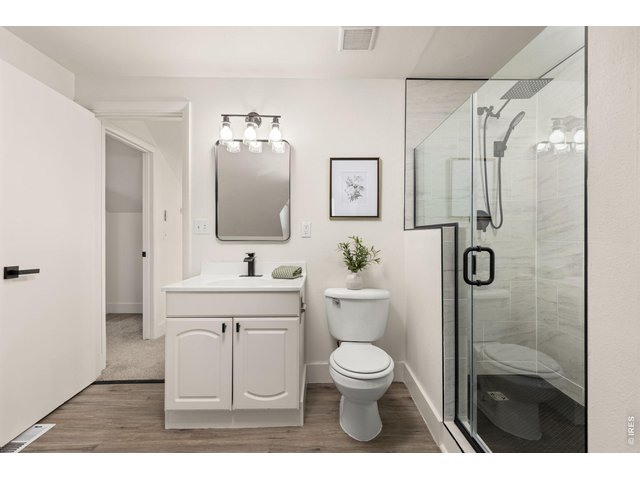Property Photo 18 Second updated bath features a walk-in shower and clean, simple finishes.