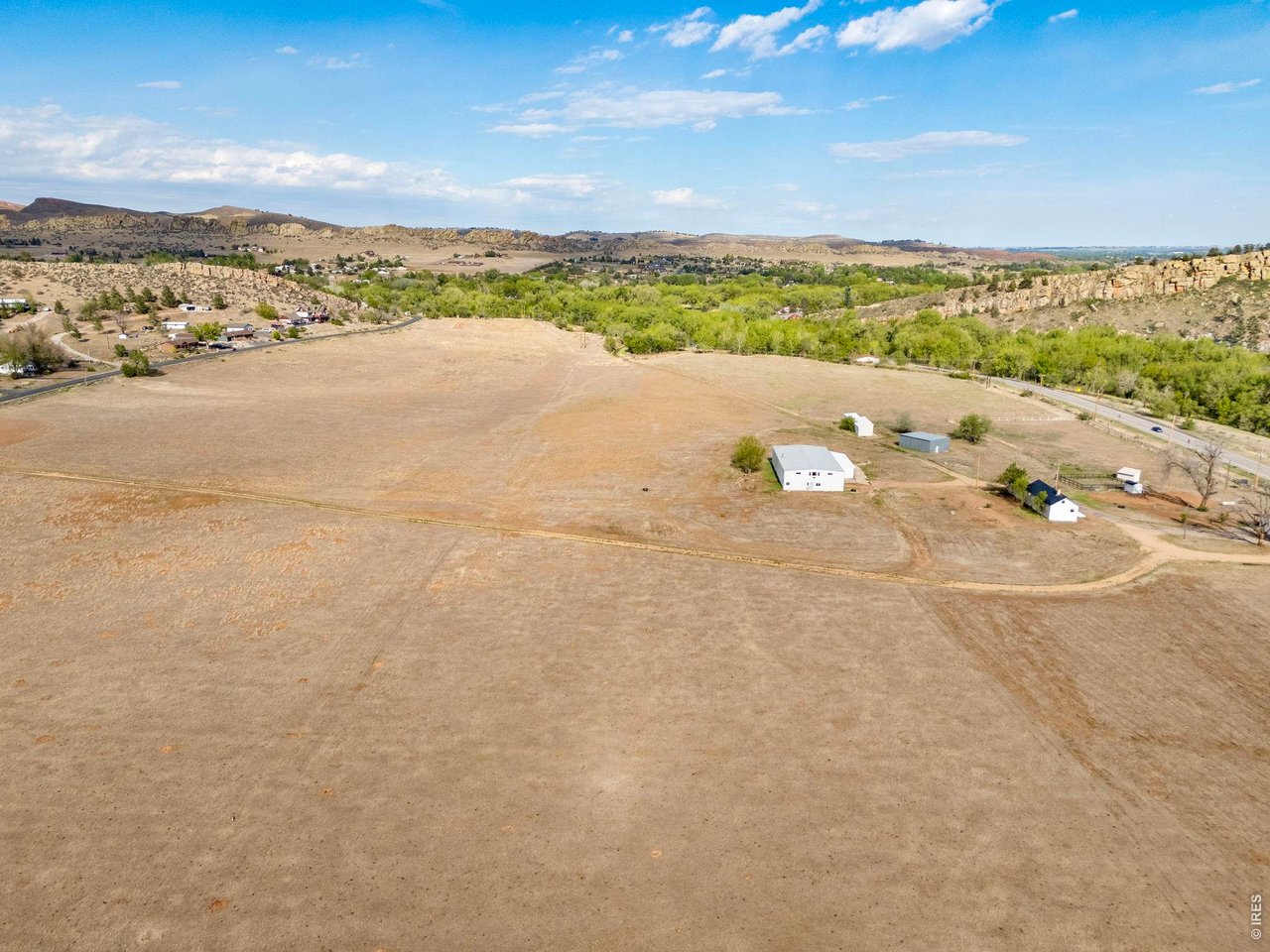 Property Photo 3 Expansive open acreage forms the heart of this unique West Loveland property, complemented by water rights and multiple improvements.