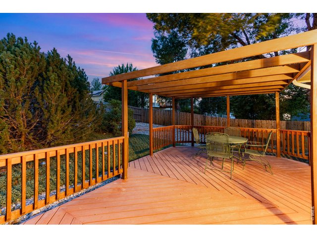 Property Photo 4 Large deck with pergola and mature landscaping