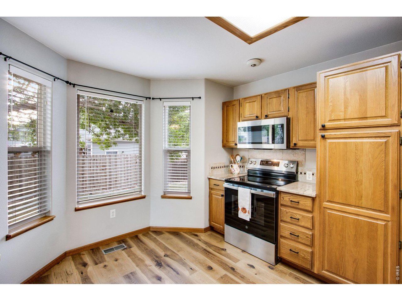 Property Photo 16 South facing dining area for plenty of natural light features a new light fixture on a dimmer switch