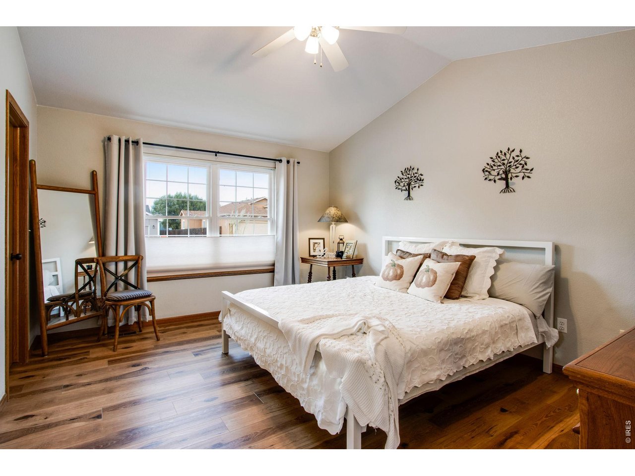 Property Photo 19 Primary bedroom features vaulted ceilings, ceiling fan, walk-in closet and a 5-piece private bath with granite slab countertop, tile flooring, new lighting, and new cabinets with hardware
