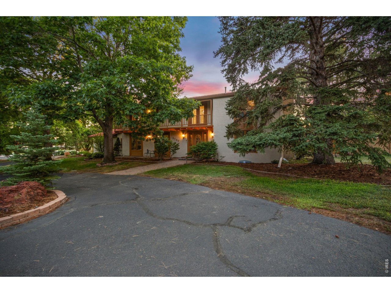 Property Photo 40 Expansive front courtyard and mature landscaping create a warm first impression.