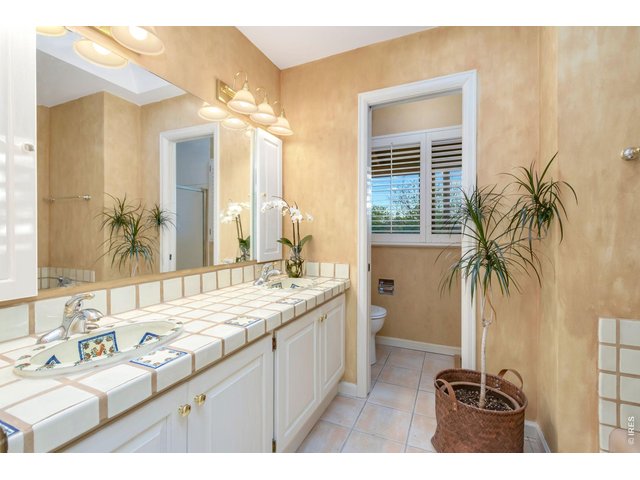 Property Photo 31 Upstairs hall bath with dual vanities, soaking tub, and separate shower. Custom hand-painted artisan sinks add unique character.