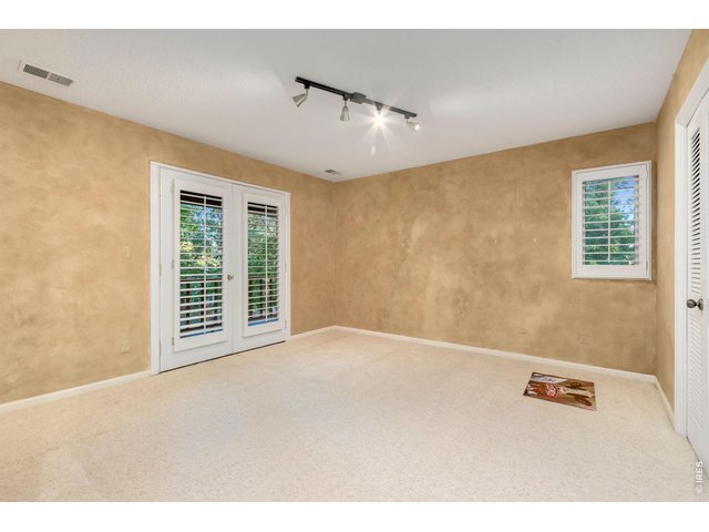 Property Photo 32 Spacious fourth bedroom with balcony access and generous closet.