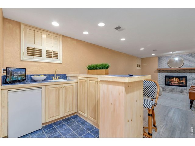 Property Photo 37 Basement wet bar. New luxury vinyl plank flooring throughout the basement.