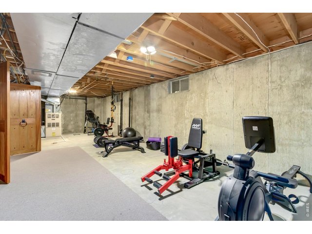 Property Photo 39 Flexible unfinished room ideal for a home gym, workshop, or hobby space. (Not shown Additional oversized storage room with built-in shelving and cedar lined closet)