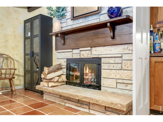 Property Photo 21 Beautiful fossil stone wood-burning fireplace creates an inviting atmosphere.