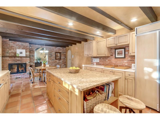 Property Photo 8 Built-in refrigerator and extensive cabinetry provide exceptional storage.