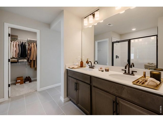 Property Photo 16 The primary bathroom has dual vanities and an amazing closet!