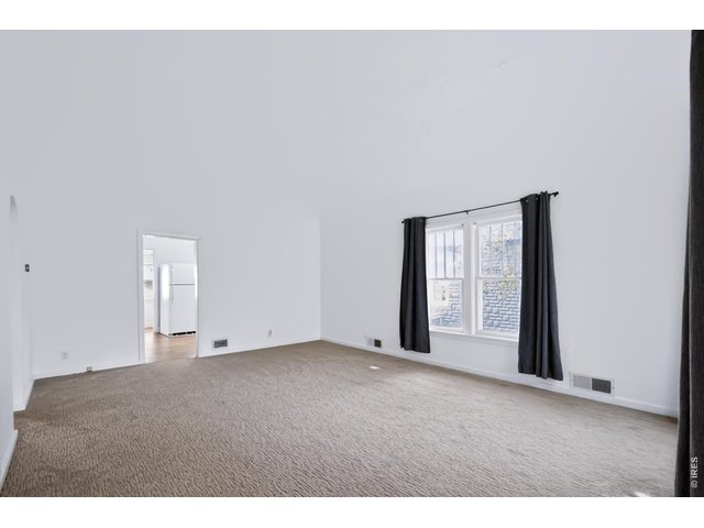Property Photo 6 Large living room with coved ceilings.