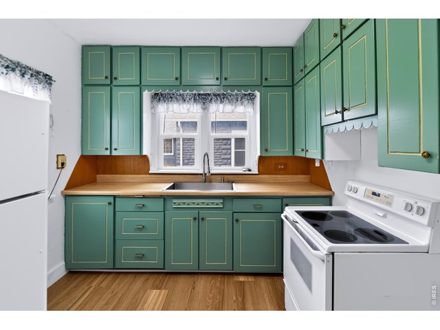 Property Photo 12 Charming original cabinets with a great pop of color.