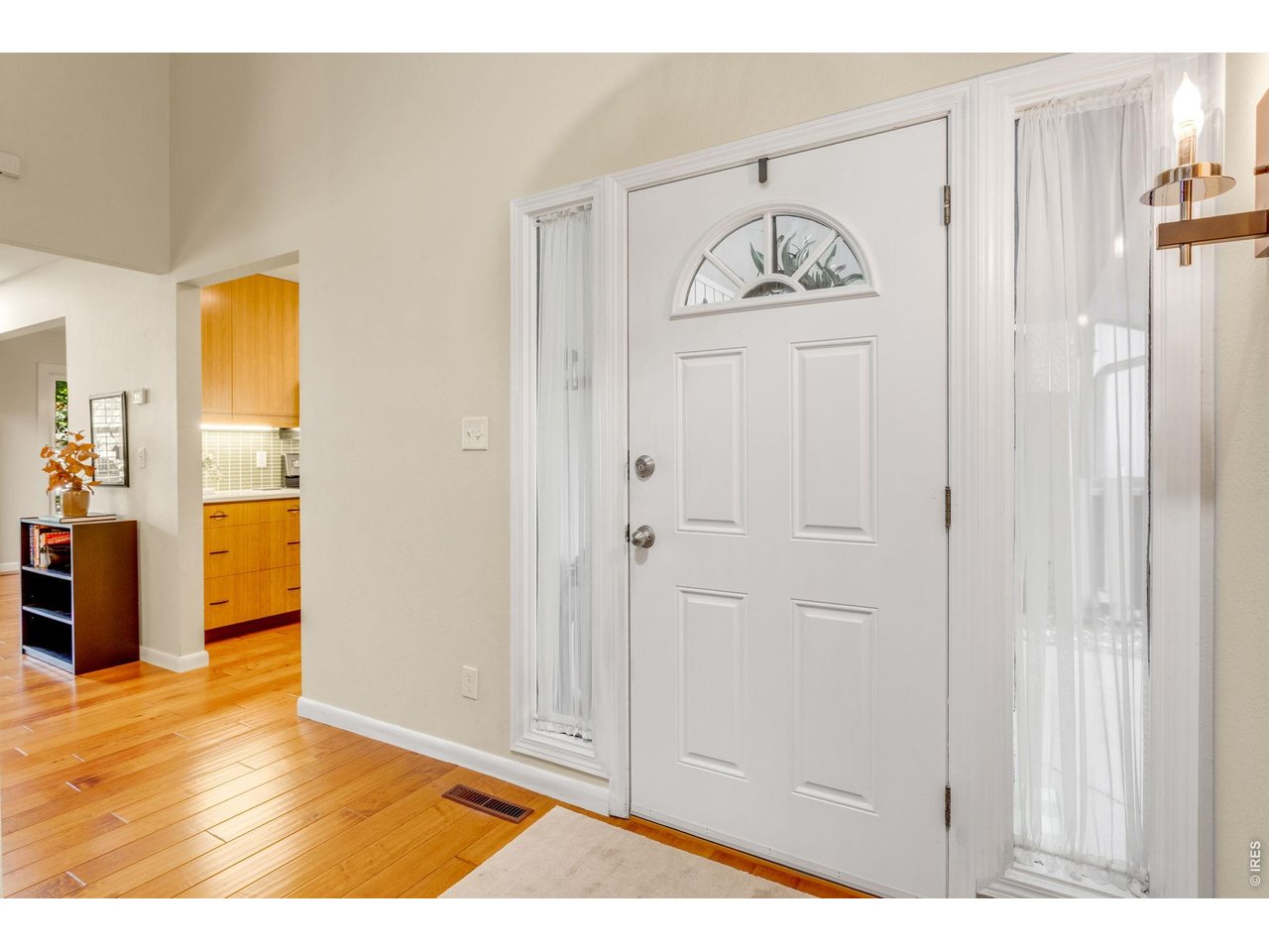 Property Photo 8 Hand-scraped Acacia wood floors, soaring ceiling in the entry, super flexible split floor plan, with 2 oversized suites/living areas + a well appointed lower level office!