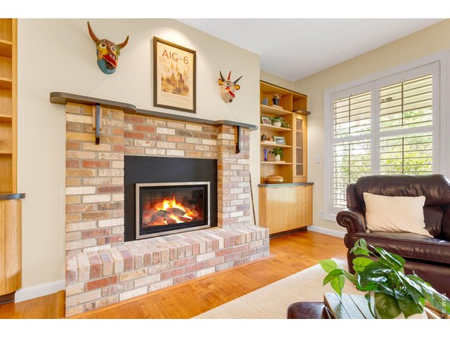 Property Photo 12 Gorgeous Centerpiece in the main level living area, hand-scraped acacia hardwood floors & plantation shutters grace the whole south side!