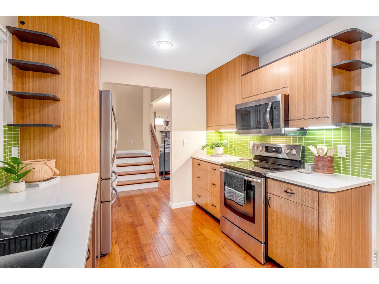 Property Photo 17 Loaded with excellent storage. Utility cabinetry, under cabinetry lighting, even the upper rails on the stairs have the same in-lay within the cabinetry doors!