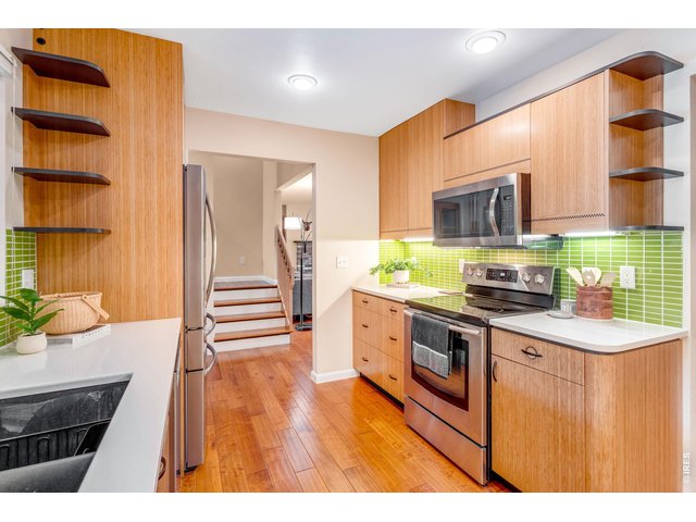 Property Photo 17 Loaded with excellent storage. Utility cabinetry, under cabinetry lighting, even the upper rails on the stairs have the same in-lay within the cabinetry doors!