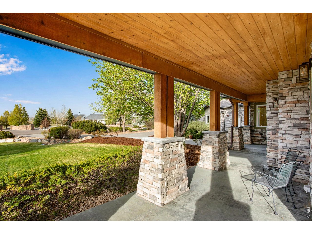 Property Photo 13 Front wraparound covered patio with tongue and groove pine ceiling