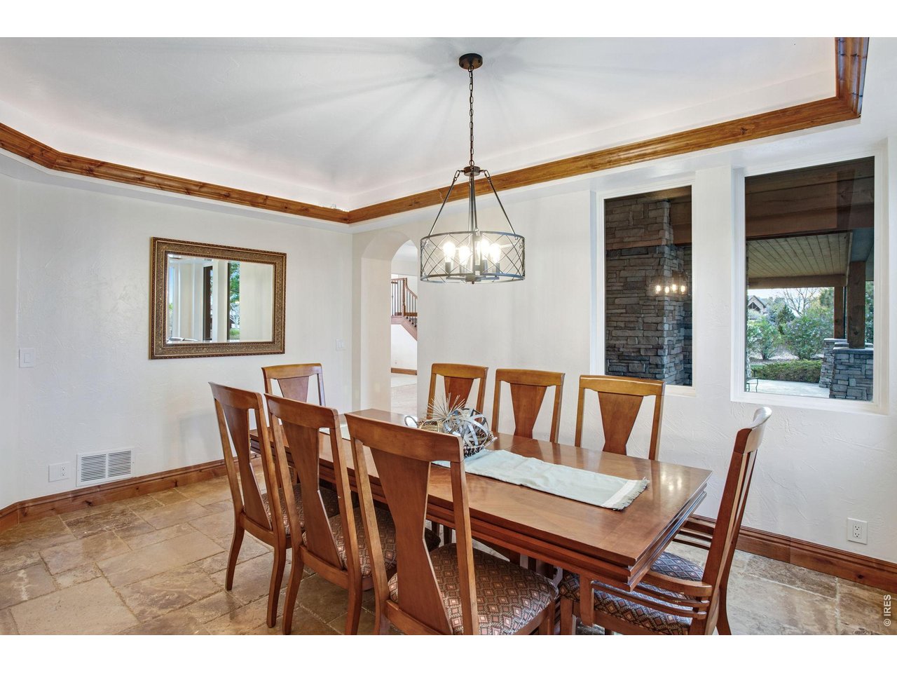 Property Photo 22 Front formal dining area features trey ceiling, crown molding with rope lighting and a circular chandelier