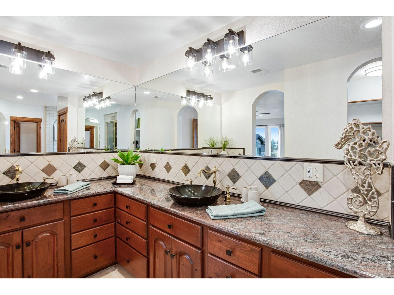 Property Photo 34 5-piece luxury bath with door to throne, 2 lifted vanities, granite slab countertops, full tile backsplash, full length corner mirrors, 2 new light fixtures, jetted soaking tub
