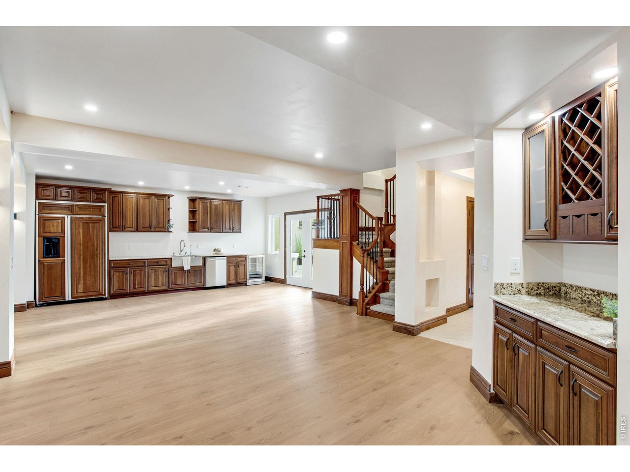 Property Photo 40 Basement Kitchenette featuring granite slab countertops, full size built in 48" cabinet paneled refrigerator/freezer, dishwasher and beverage cooler. Wired for electric range/oven