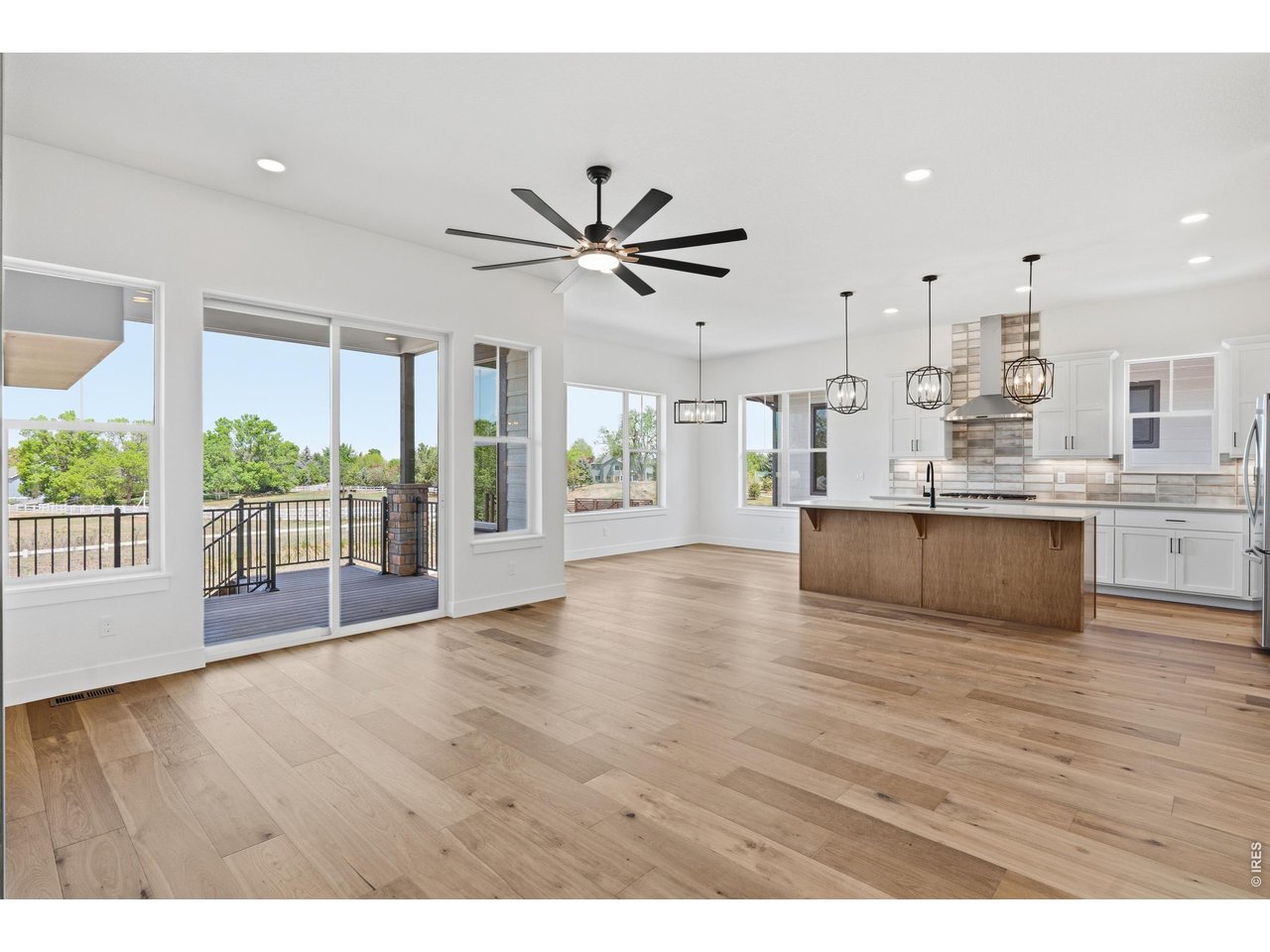 Property Photo 3 Bright and open main living area with soaring ceilings, oversized windows, and seamless indoor-outdoor flow.