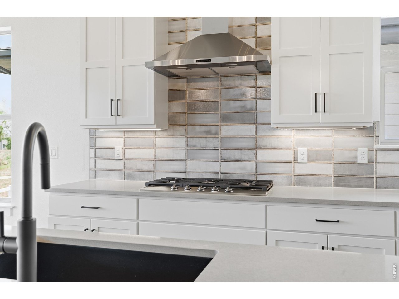 Property Photo 5 Elevated finishes throughout including upgraded tile work, matte black fixtures, and high-end appliances.