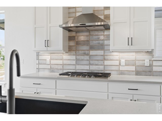 Property Photo 5 Elevated finishes throughout including upgraded tile work, matte black fixtures, and high-end appliances.