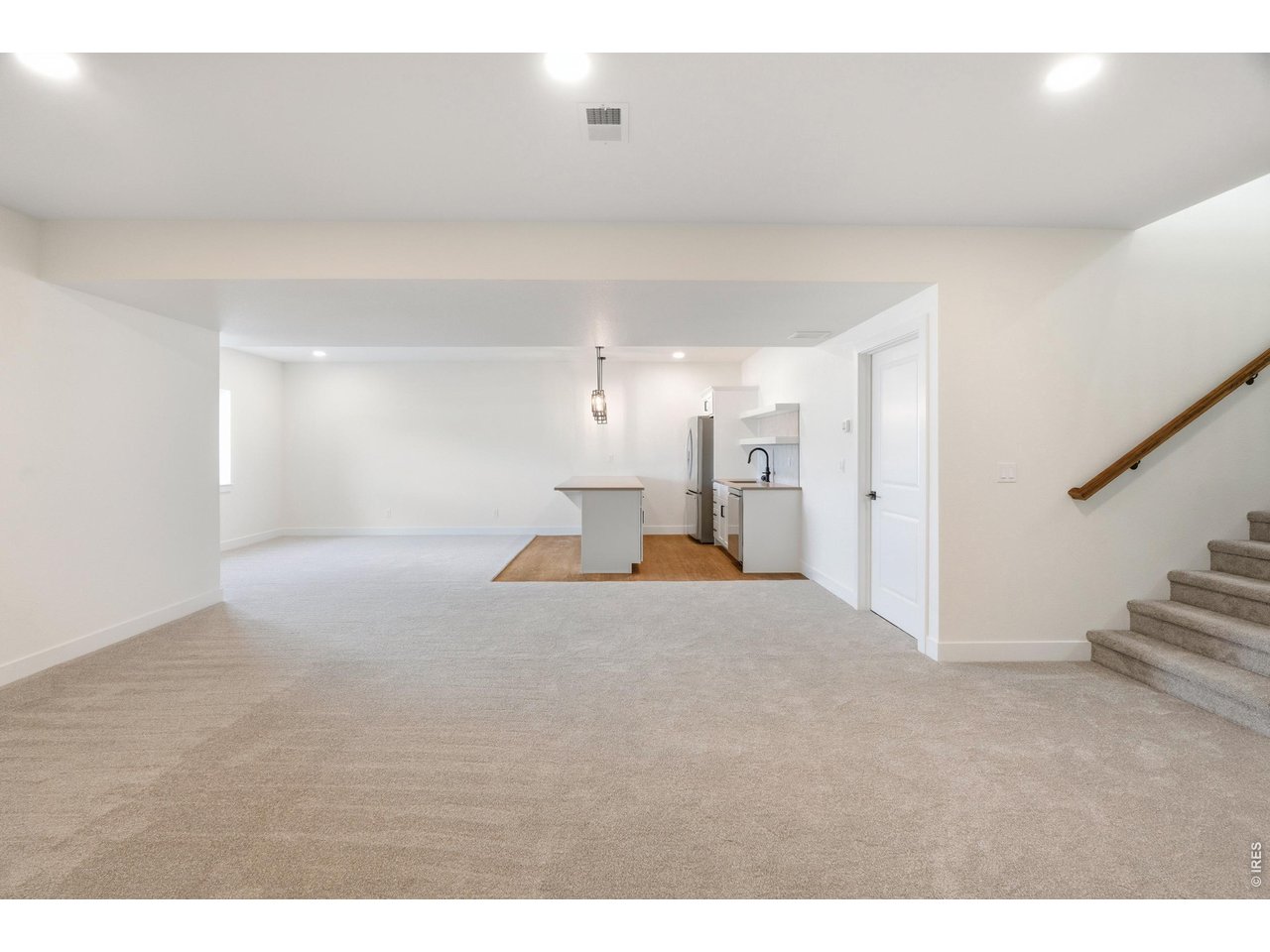 Property Photo 18 Fully finished basement with expansive rec space, wet bar, and endless flexibility for entertaining, movie nights, or hosting guests.