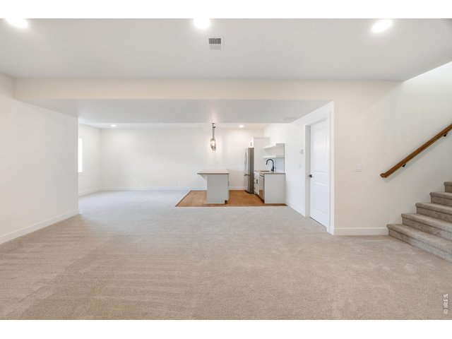Property Photo 18 Fully finished basement with expansive rec space, wet bar, and endless flexibility for entertaining, movie nights, or hosting guests.