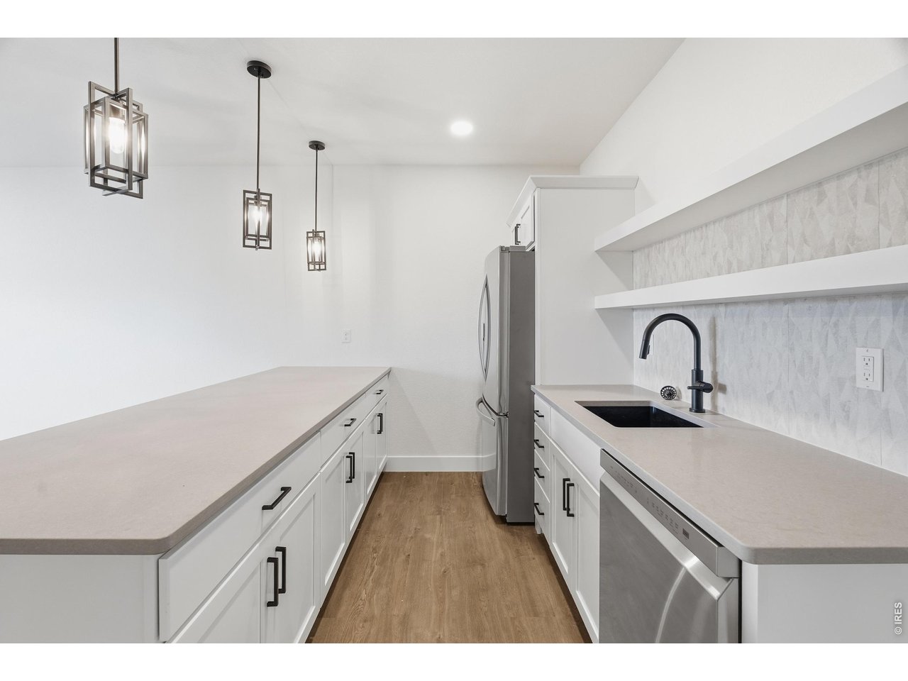 Property Photo 20 Stylish lower-level wet bar with generous counter space, open shelving, and full appliance package for effortless entertaining.