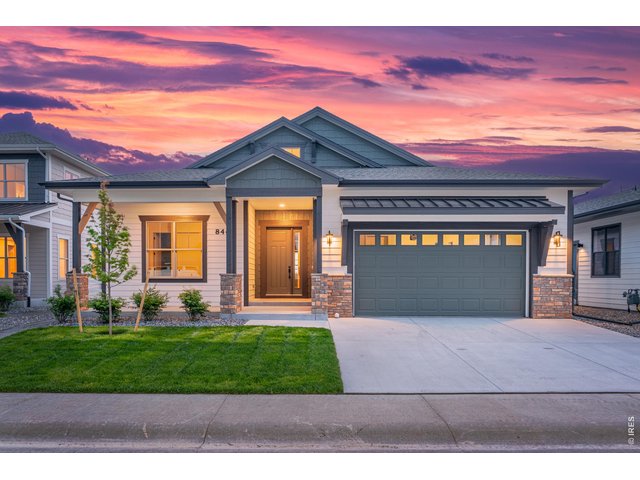 Property Photo 31 Modern farmhouse-inspired exterior with upgraded architectural details, oversized driveway, and welcoming covered entry.