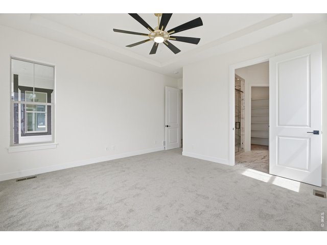 Property Photo 8 Spacious primary retreat with tray ceilings and direct access to the spa-inspired ensuite.