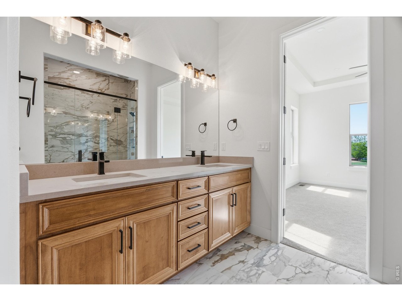 Property Photo 11 Double vanity with abundant storage and elevated designer finishes throughout the primary bath.