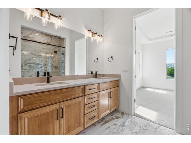 Property Photo 11 Double vanity with abundant storage and elevated designer finishes throughout the primary bath.