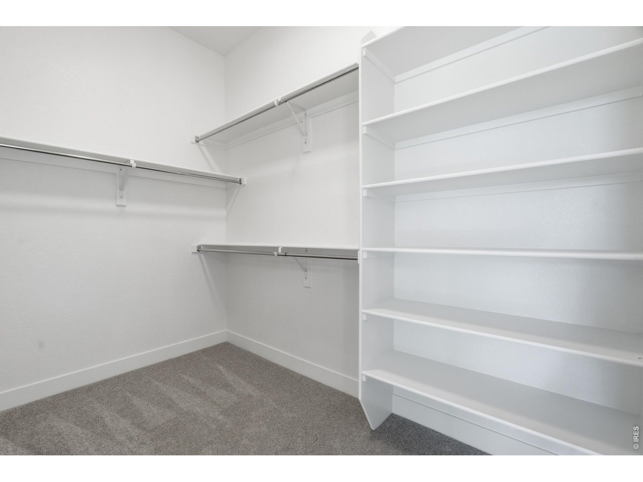Property Photo 12 Large walk-in closet with custom shelving and plenty of room for organization.