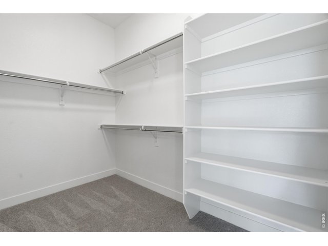 Property Photo 12 Large walk-in closet with custom shelving and plenty of room for organization.