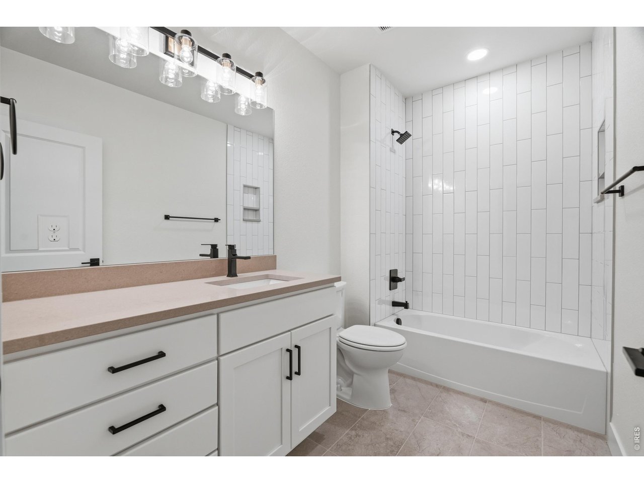 Property Photo 23 Full basement bathroom finished with timeless tile work, matte black fixtures, and clean modern design.
