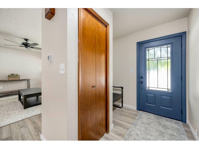 Property Photo 7 Formal entry with new door and LVP flooring spans the main level.