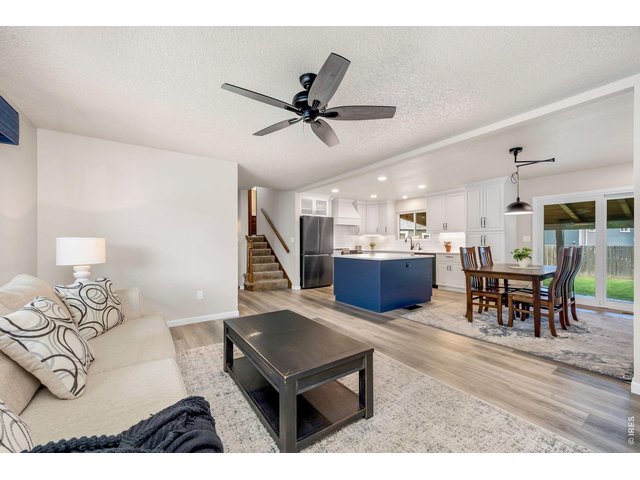 Property Photo 10 Main floor living room opens to kitchen and dining areas.