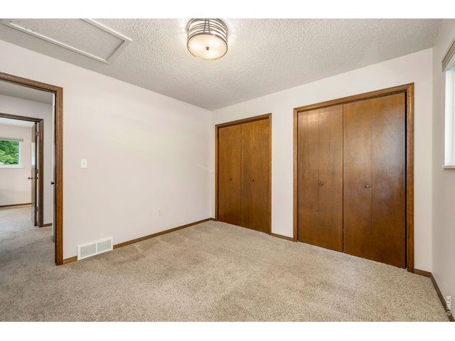 Property Photo 28 Upper level bedroom 3 features double closets, fresh paint and new light fixture.