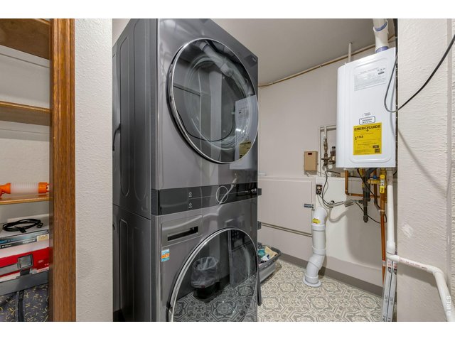 Property Photo 36 Lower level laundry includes the full size, front load stackable washer/dryer and upgraded Navien tankless hot water heater.