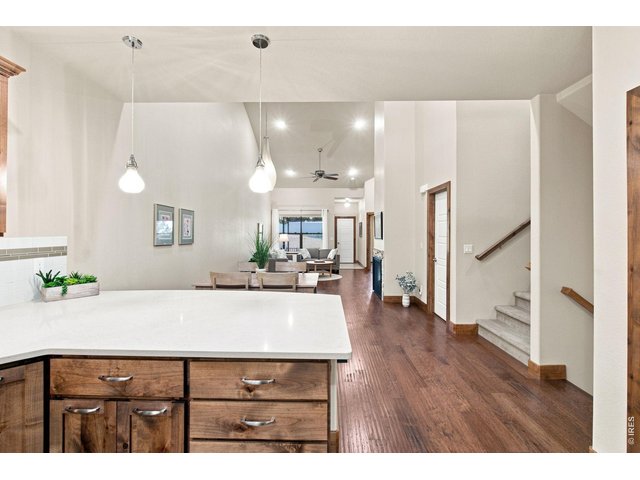 Property Photo 5 Open-concept kitchen with generous counter seating flows seamlessly into the dining and living areas perfect for everyday living and entertaining.