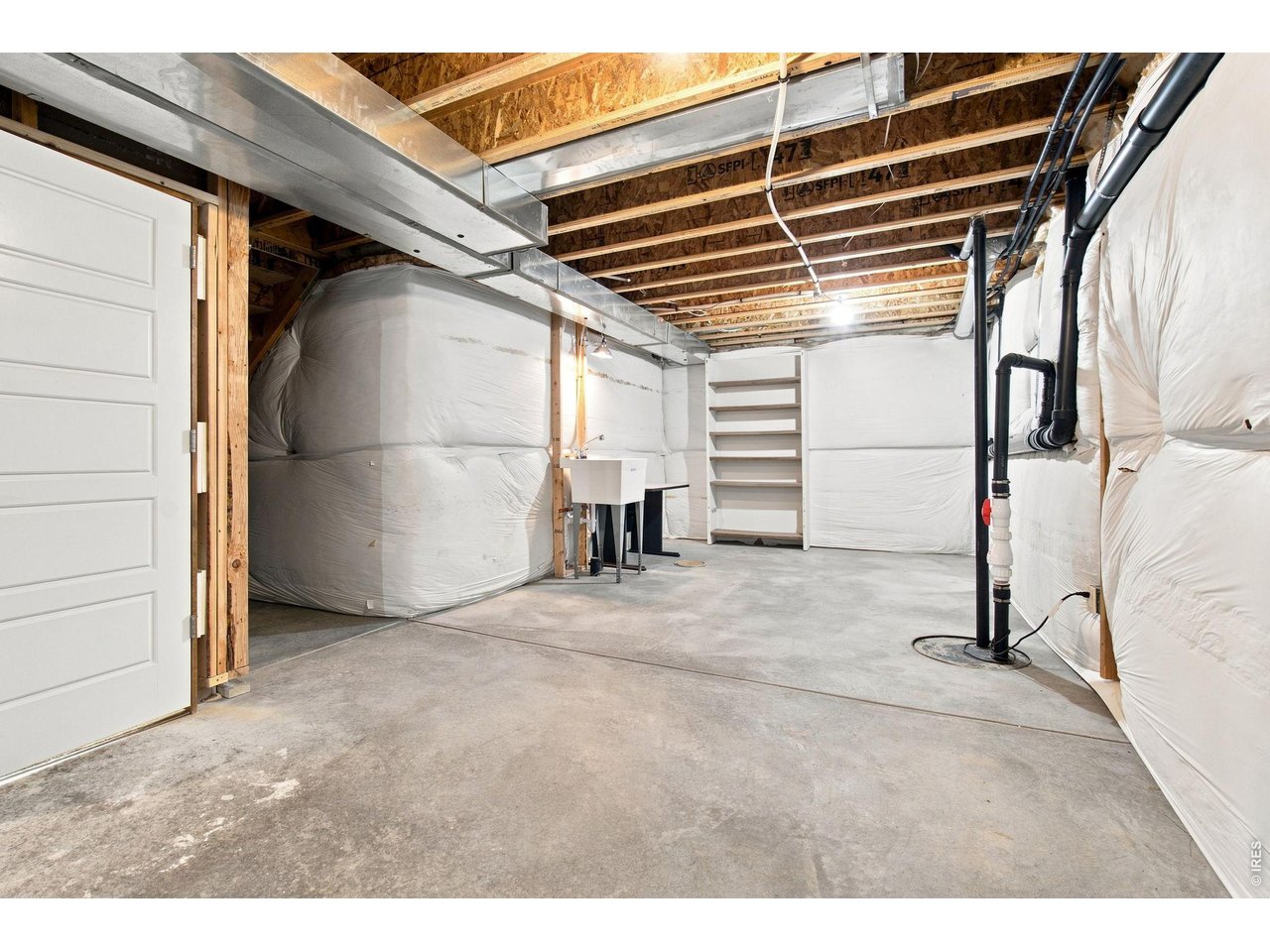 Property Photo 23 Spacious unfinished basement offers excellent storage and plenty of potential for future finishing.