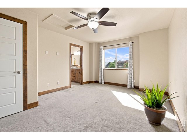 Property Photo 19 Spacious upstairs en-suite with abundant natural light, ceiling fan and private bath.
